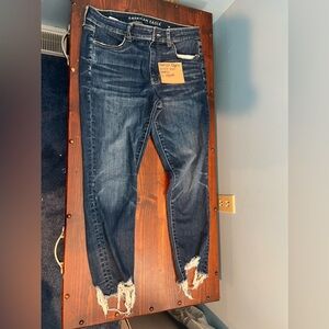 American Eagle next level stretch straight leg jeans with frayed ends.